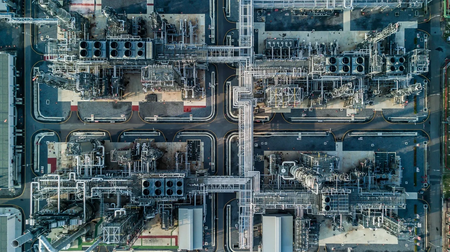 A large industrial area with many pipes and buildings.