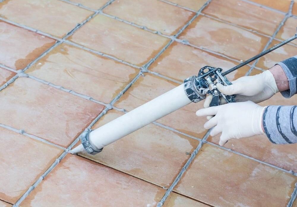 A person is using a hose to clean the roof of a house.